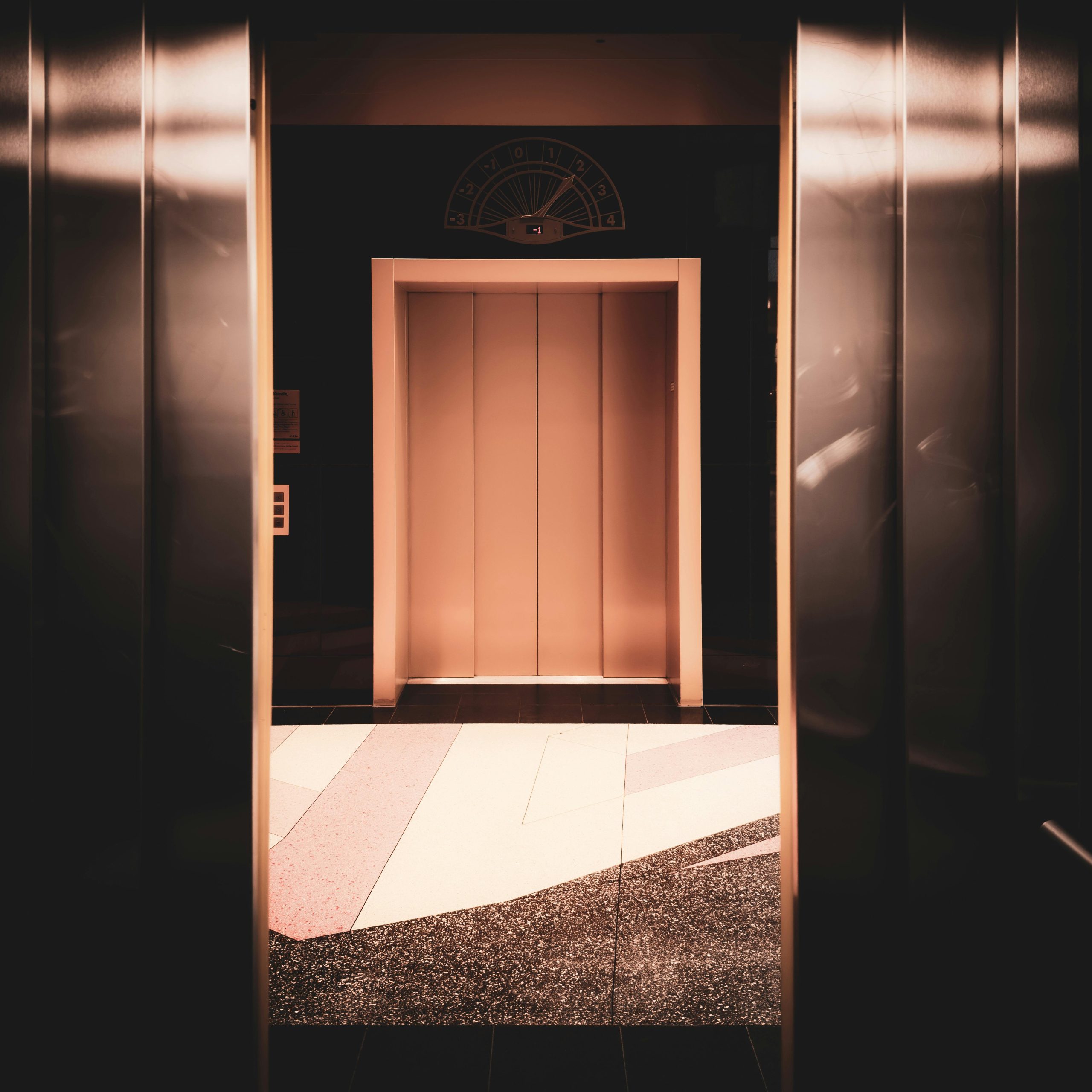 A view of a modern elevator interior with warm lighting in Berlin, Germany.