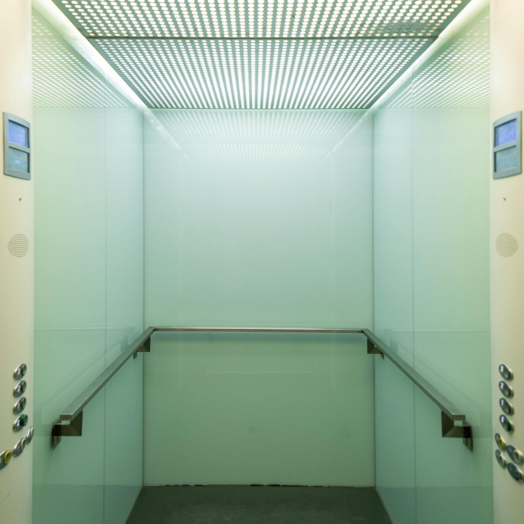 pexels-photo-8243095-8243095 Empty elevator cabin showcasing a clean and minimalist interior with soft lighting.